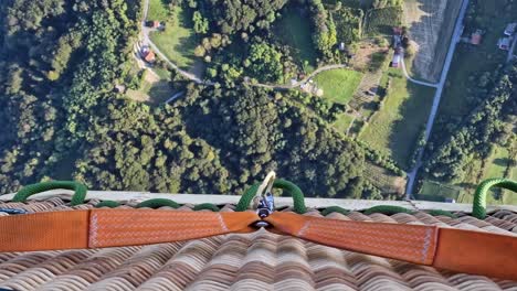 Top-down-view-from-air-balloon-basket-while-taking-off-and-traveling-above-touristic-travel-hot-spot-destination