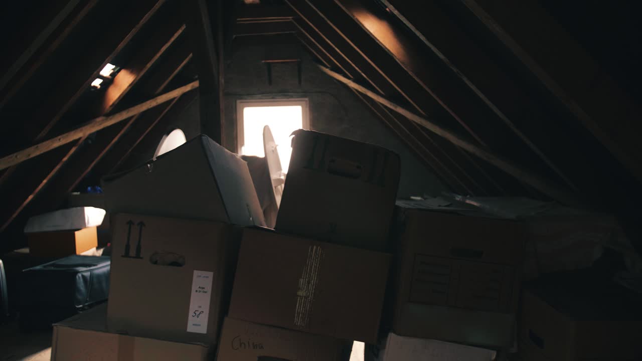 Dark and Cluttered Attic Filled with Cardboard Boxes