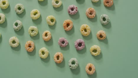 video of colorful breakfast round cereals on blue background