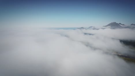 cinematic fpv drone shot stabilized from lofoten revealing mountains from behind the clouds