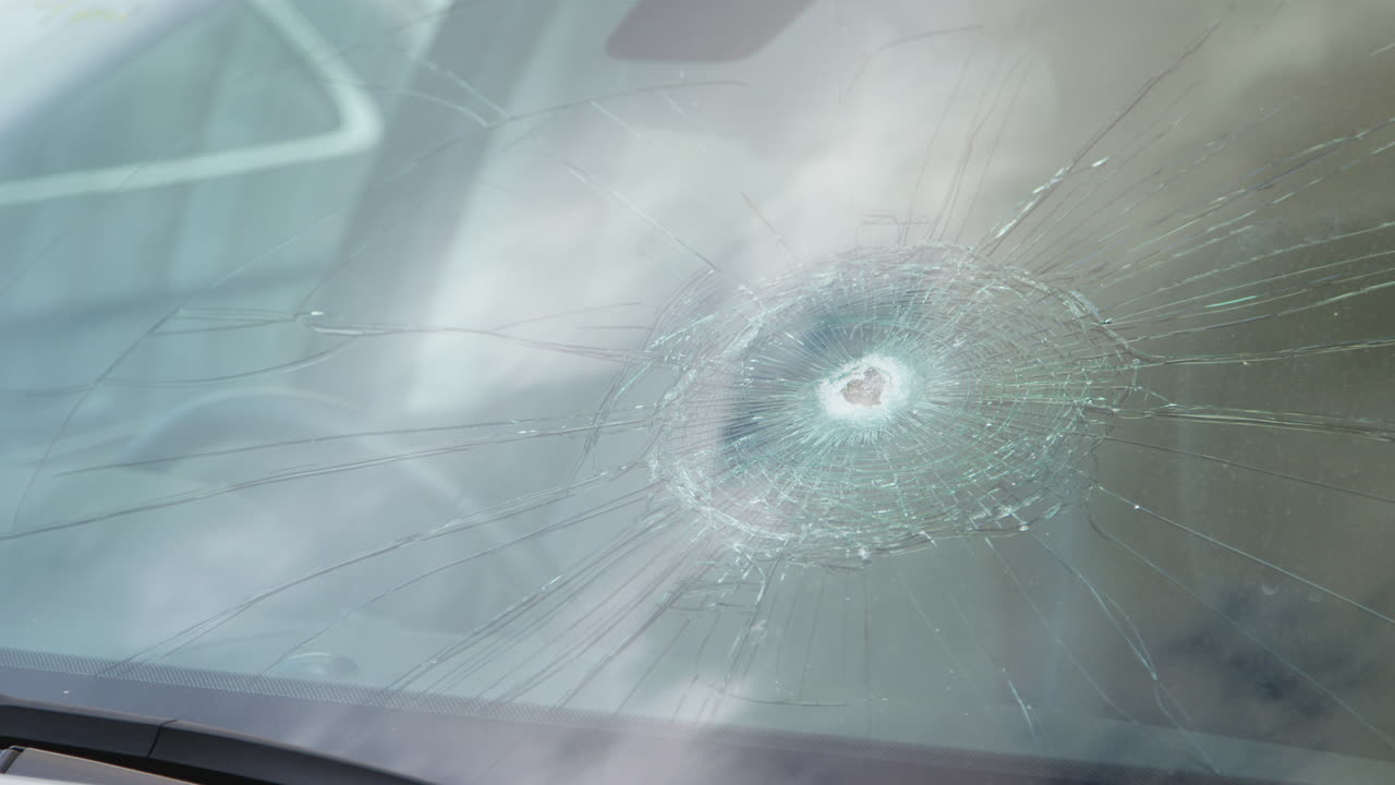 Detail Of Damage To Windscreen Of Car Shattered By Vandalism