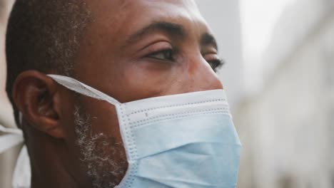 african american man on the go wearing coronavirus covid19 mask