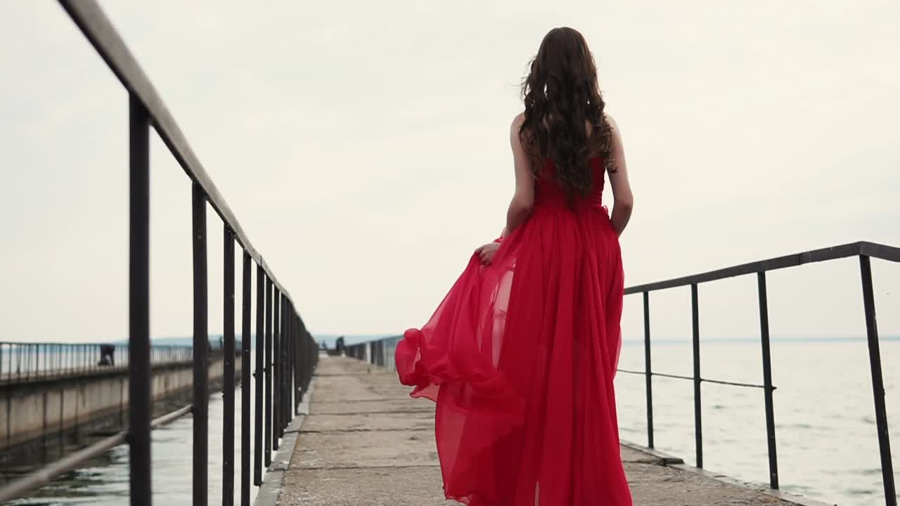 Woman in Red Dress Walking on a Pier
