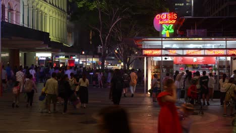 vibrant nightlife of brisbane city, a bustling downtown with massive crowds of people paced in queen street mall after river fire event, influx of population, fast time-lapse motion shot.