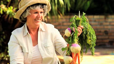 mature woman with root vegetables