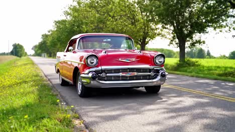classic red chevrolet convertible on a country road