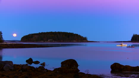 a beautiful evening shot along the maine or new england coast with moon rising