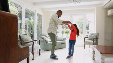 father and daughter dancing in kitchen 4k