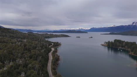 following aerial movement at the main road near the lakeshore of nahuel huapi lake, villa la angostura, argentina.