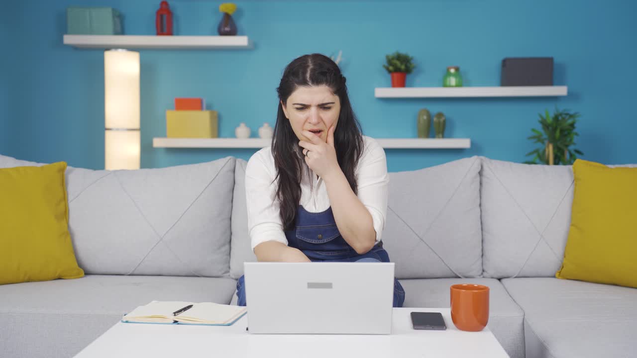 mujer mirando la computadora portátil con asombro.