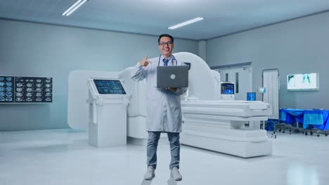 full body of asian male doctor smiling and pointing to a laptop in hand while standing with mri machine in the hospital