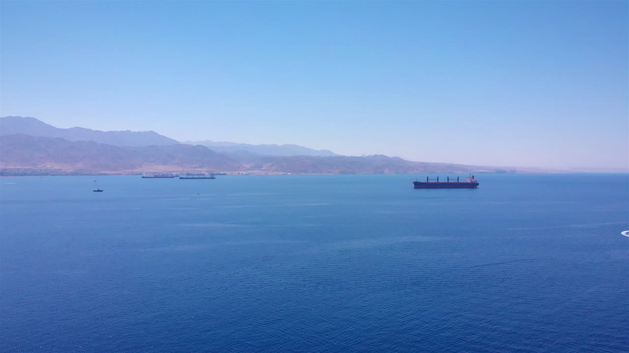 Tourists tour on old style pirate ship on calm clear drak blue sea Aerial top down view