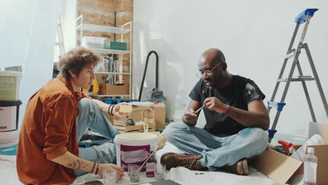 couple discussing paint samples and sharing home renovation ideas