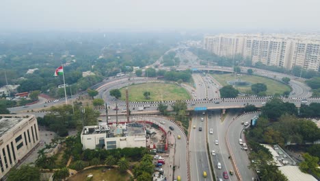 aerial drone shot displaying a bird’s-eye view of heavy traffic congestion on a delhi flyover, with vehicles stretching into the distance.