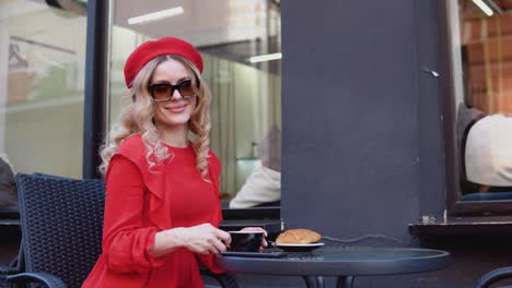 aesthetics of red and black colors. french breakfast. young romantic woman drinking coffee with a croissant