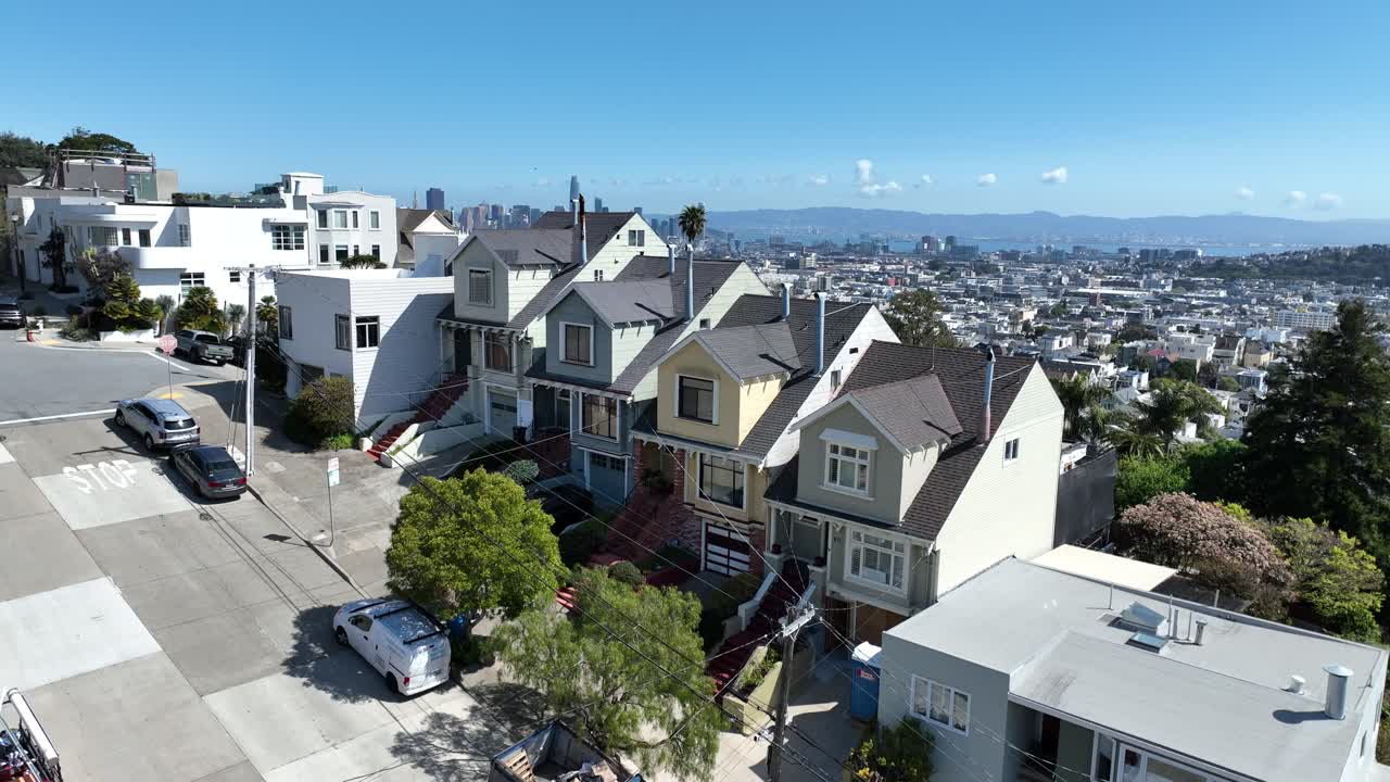 Rising San Francisco homes aerial with skyline in background