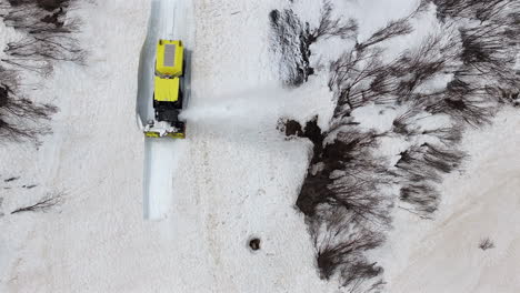 aerial shot snowplough ejecting snow closed road pass access spring time savoir france