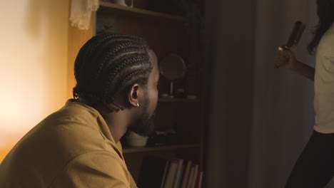 Young-Couple-Relaxing-At-Home-At-Night-Talking-Together-1