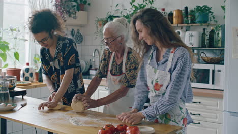 elderly woman kneading dough with grandkids in home kitchen