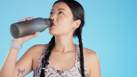 Athlete,-fitness-and-woman-drinking-water-bottle