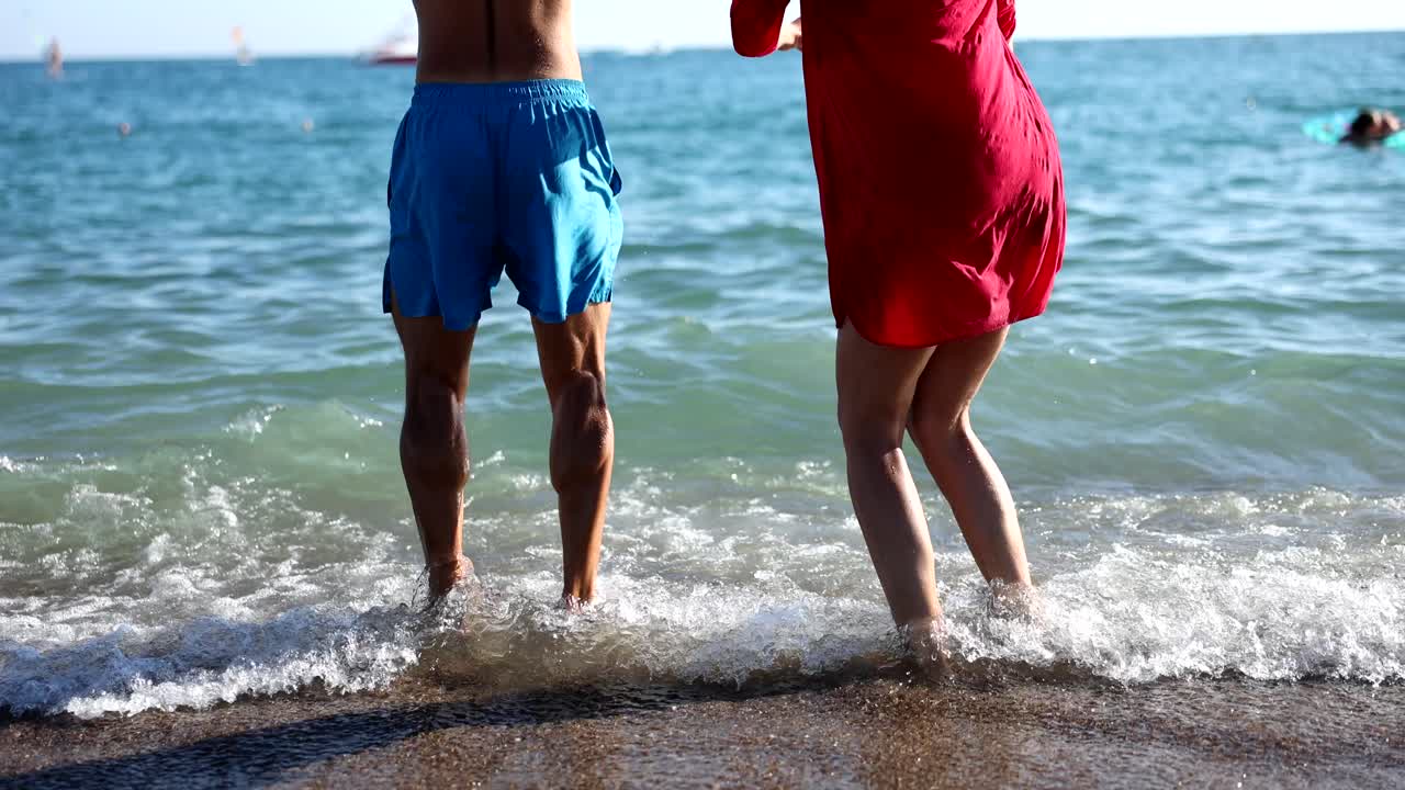 People Jumping in the Sea on a Sunny Day