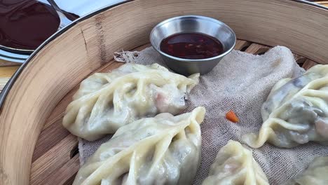 dipping vegetable dumplings i spicy sauce with chopsticks