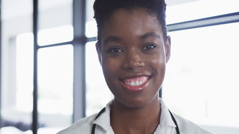 portrait of african american female doctor looking at camera and smiling