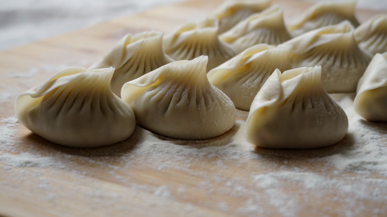 Fresh Dumplings On Floured Wooden Board, Closeup View Of Rows Of Handcrafted Pleated Dough, Soft Natural