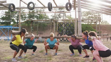 Female-friends-enjoying-exercising-at-boot-camp-together