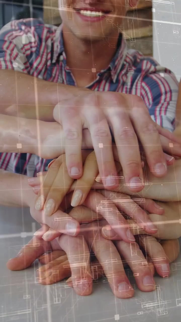 Vertical video: Team adding hands and fixing, plaid man smiling, overlay grid on hands for teamwork