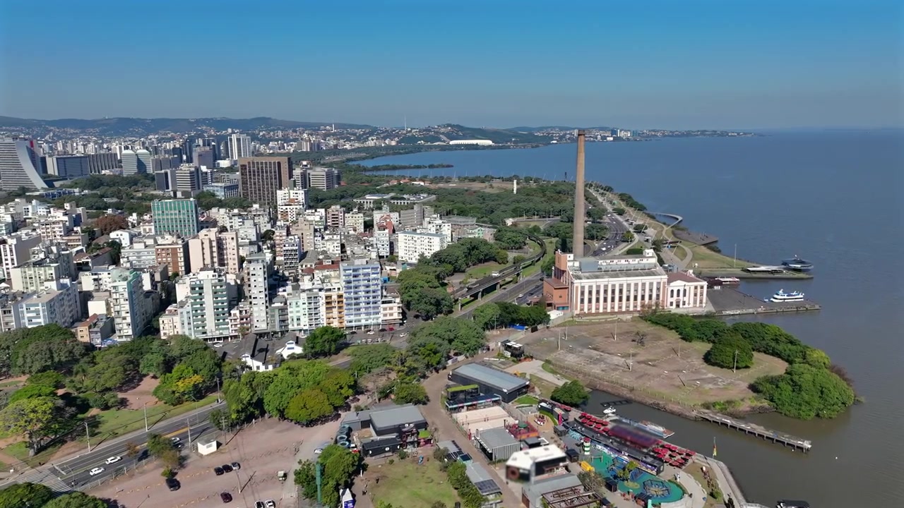 Pemandangan udara tepi laut Guaíba di Porto Alegre yang menampilkan cerobong asap Usina do Gasômetro dan cakrawala kota