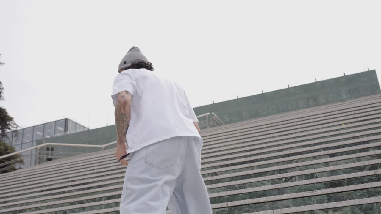 Skater performing tricks on stairs in urban environment