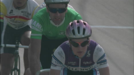 cyclists race inline on a track