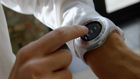 female executive using smartwatch in office 4k