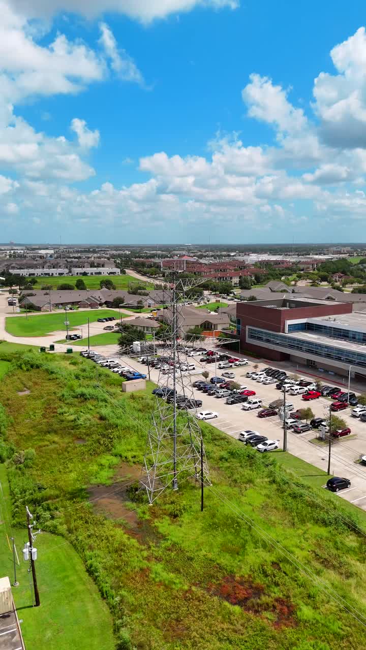 An vertical aerial view of an electric tower, connected to power lines