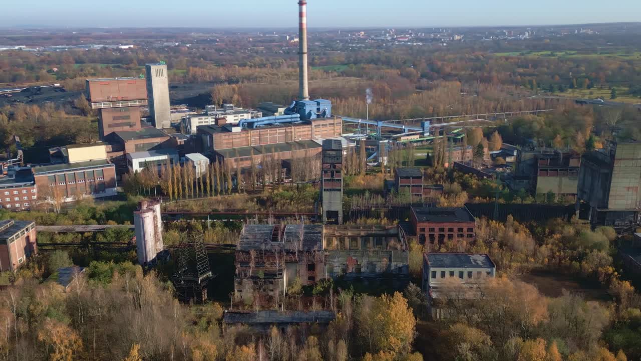 Aerial over disused Armada coal mine complex amid autumn woodland