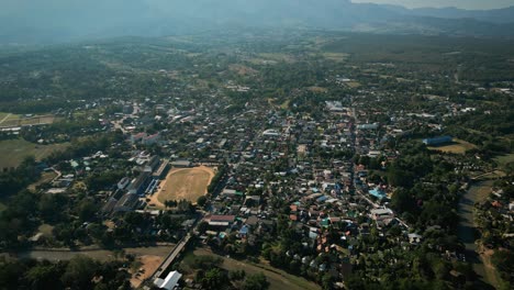 aerial scenic drone footage of the town of pai, thailand on a sunny day
