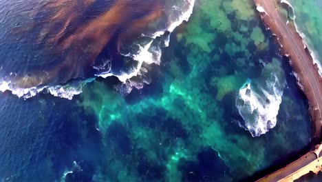 aerial view of colorful coastal pools and waves