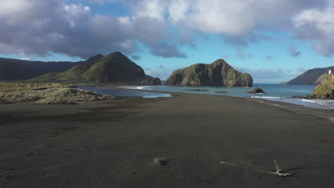 Flight-towards-scenic-Whatipu-beach-with-rocky-formations,-Huia-Reserve,-New-Zealand