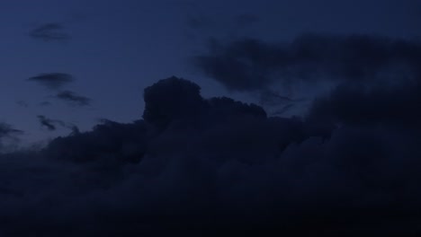 silhouettes of large buildings under deep dark blue skyline above