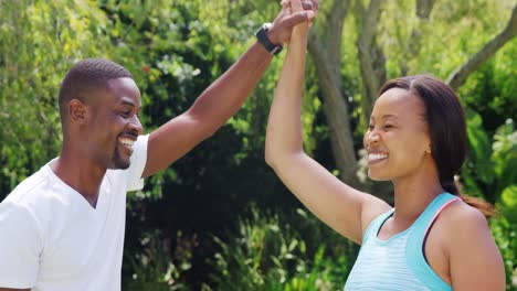 Sportswoman-clapping-the-hand-of-her-husband