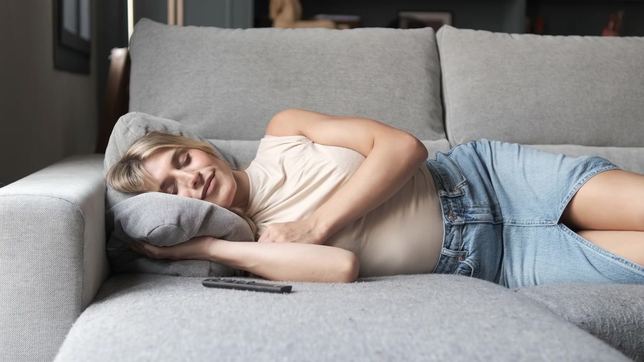 Young Woman Sleeping Peacefully on a Comfortable Sofa