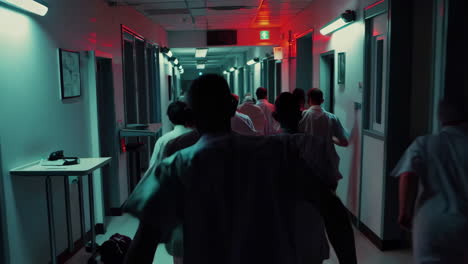 medical staff running in hospital corridor