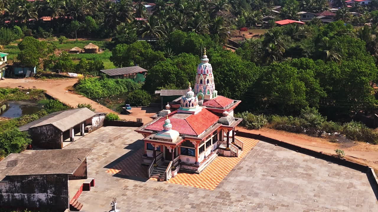 Aerial view circling the Hanuman Mandir Hindu temple, in sunny Guhagar, India