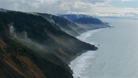 usal beach sinkyone wilderness northern california aerial drone rugged untouched coastline mist rain evaporating morning remote untouched black sand waves crashing bluffs lost coast trail static shot