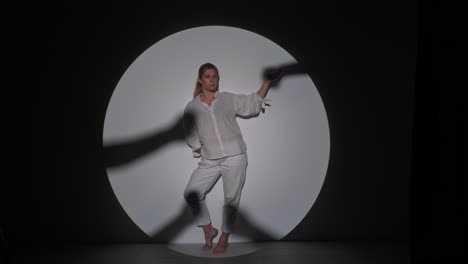 woman in spotlight with dramatic shadows
