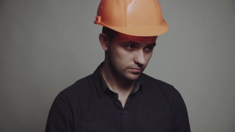 young man architect in building helmet. smiling young man architect in building helmet standing and writing on clipboard