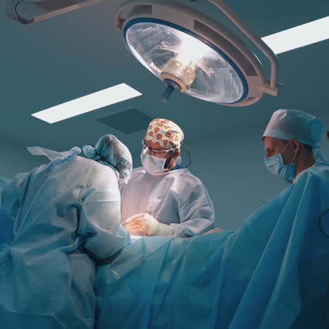 abdominoplasty of the abdomen. partial removal of fat and mucous tissues of the abdomen. the doctor cuts a laser surgical scalpel.