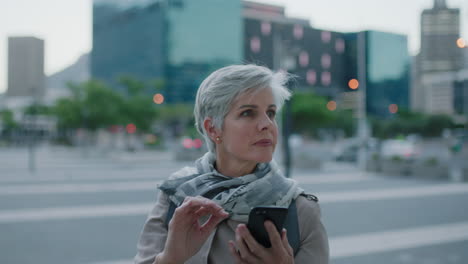 portrait-of-beautiful-mature-caucasian-woman--texting-browsing-using-smartphone-networking-app-enjoying-relaxed-urban-evening