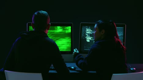 man and woman working on computers